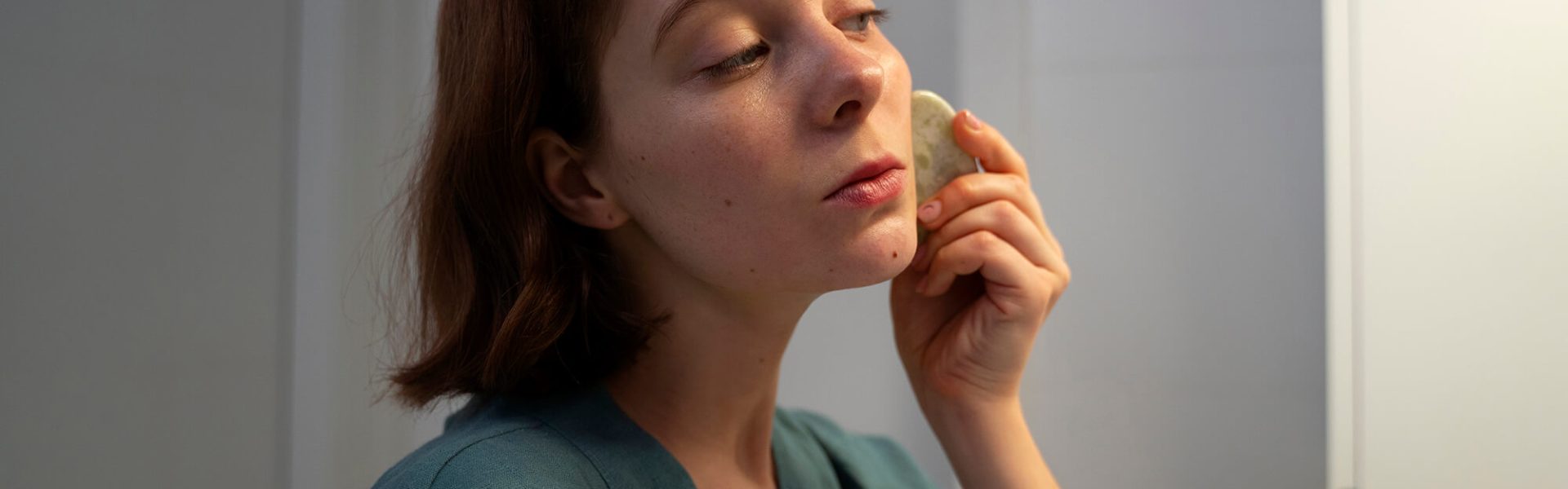 clarity-side-view-woman-using-gua-sha-massage